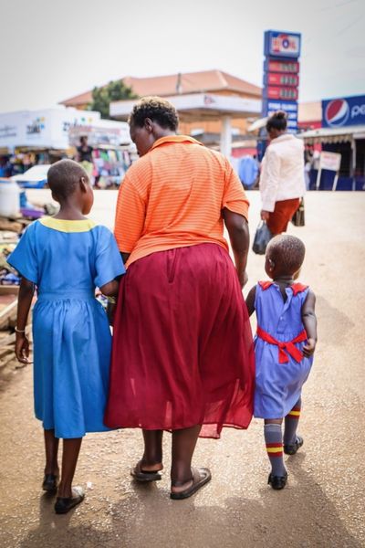 grandmother and kids walking to market